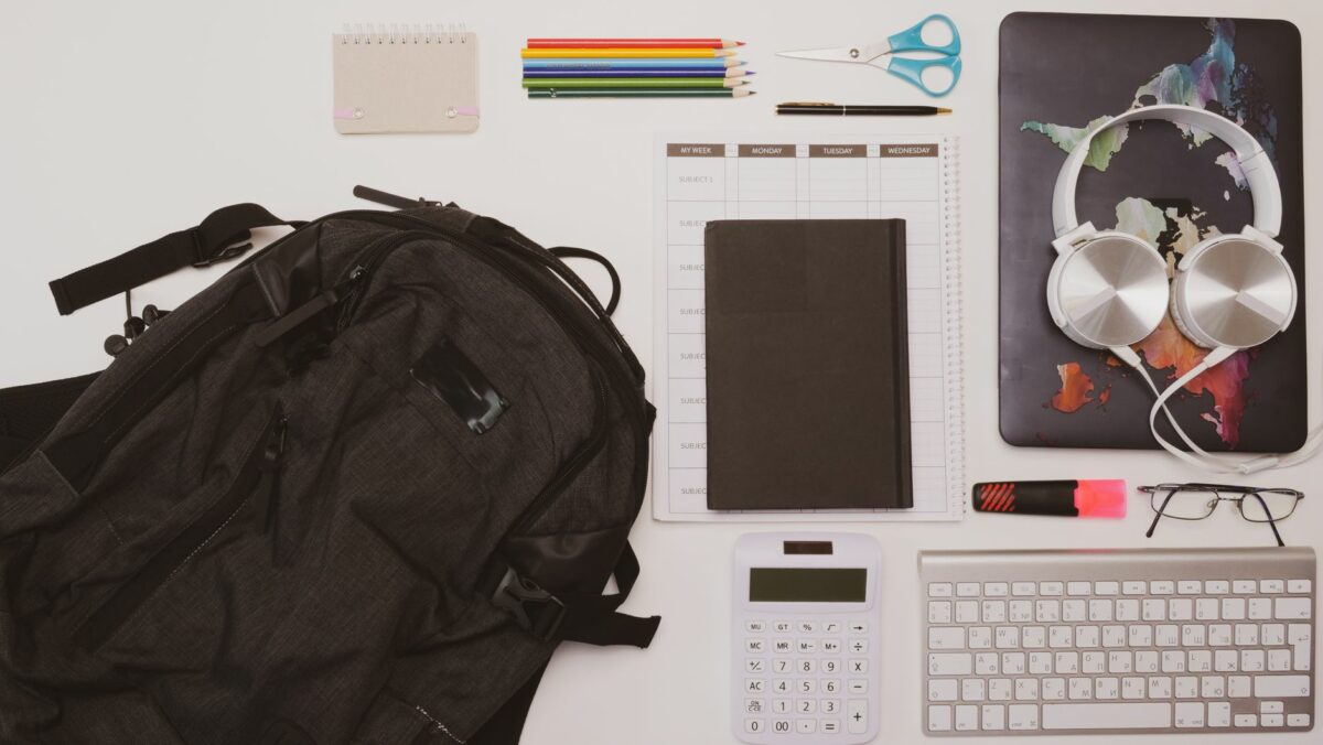 overhead shot of a backpack near a calculator